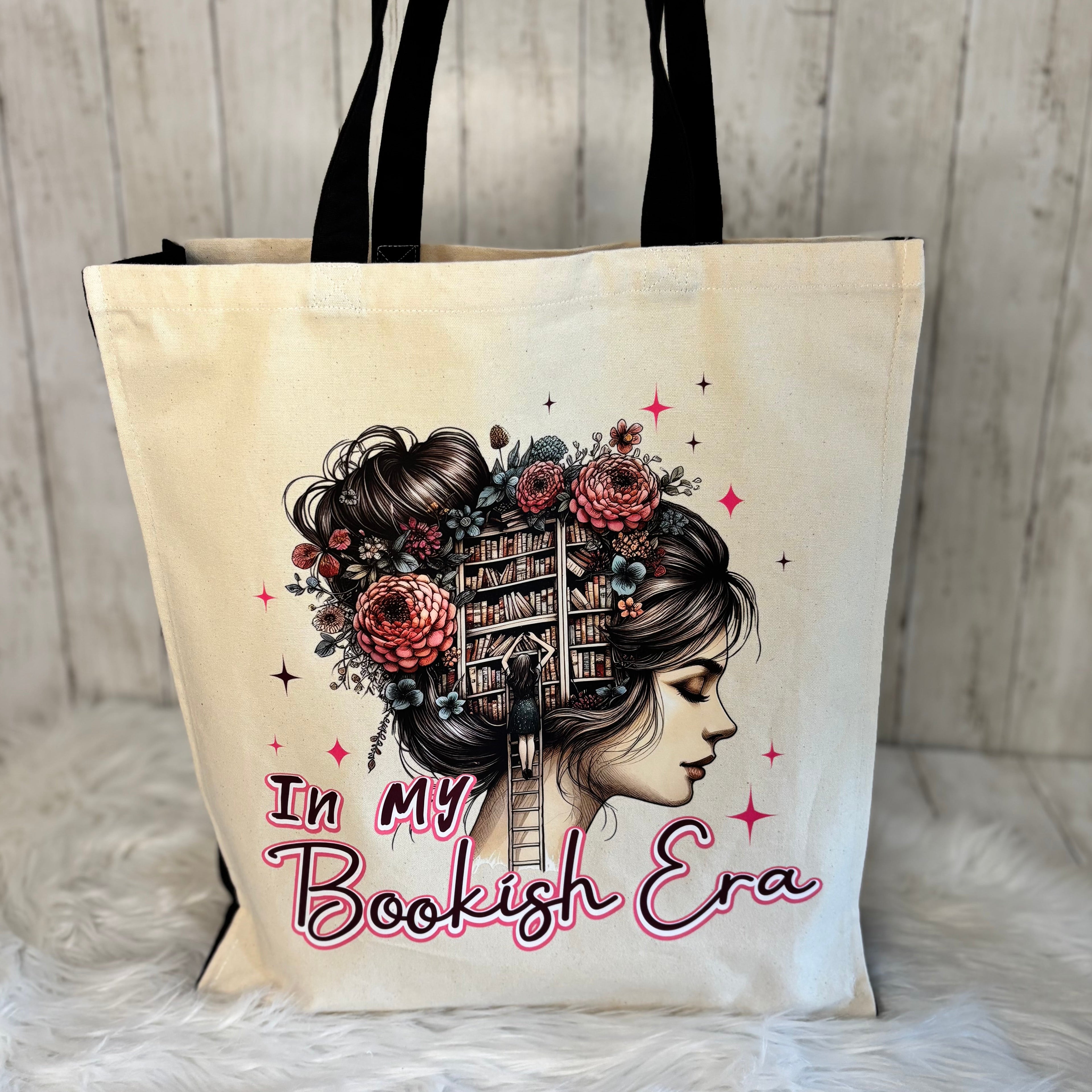 Tote bag with a design of a woman's face with flowers and text 'In My Bookish Era' 